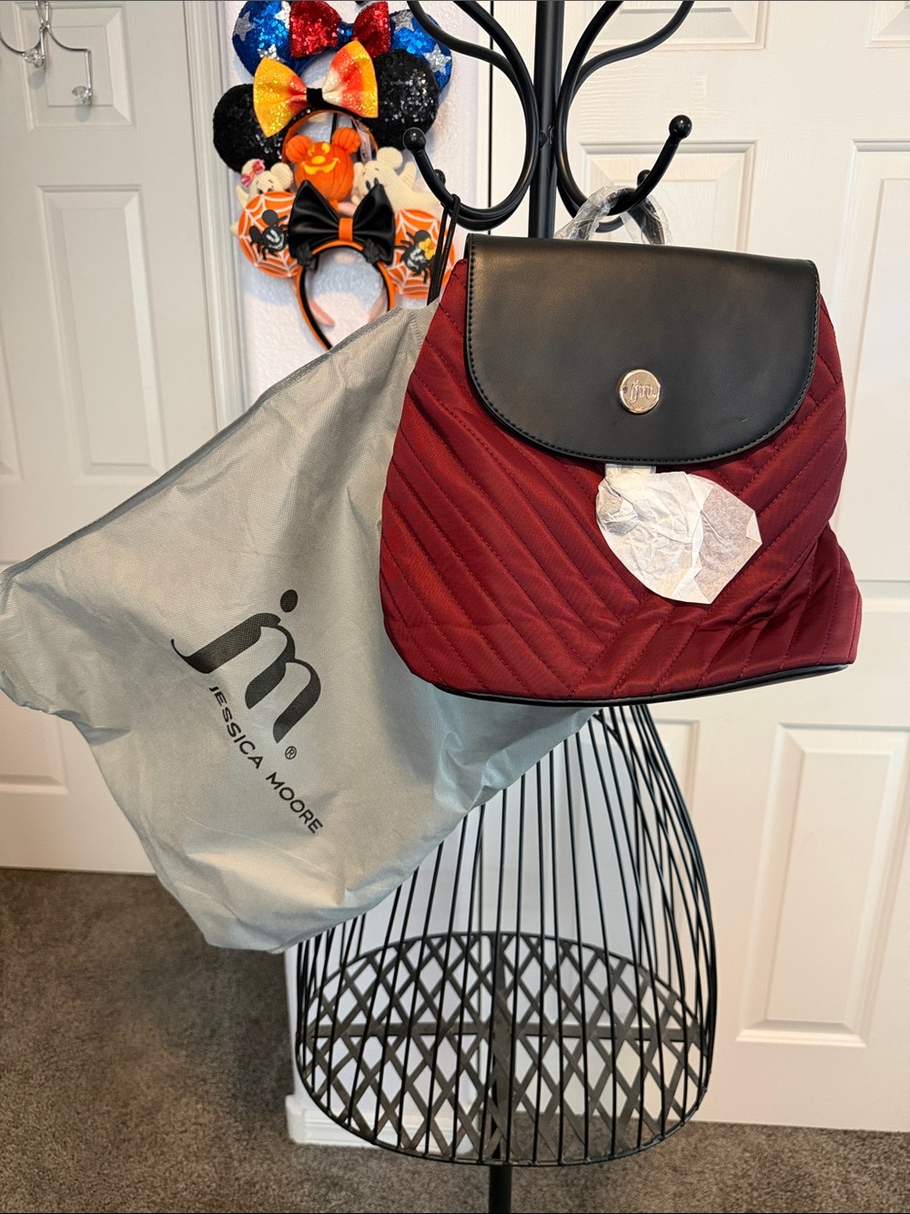 NWT Jessica Moore Burgundy Quilted Backpack with Black Flap Snap closures.